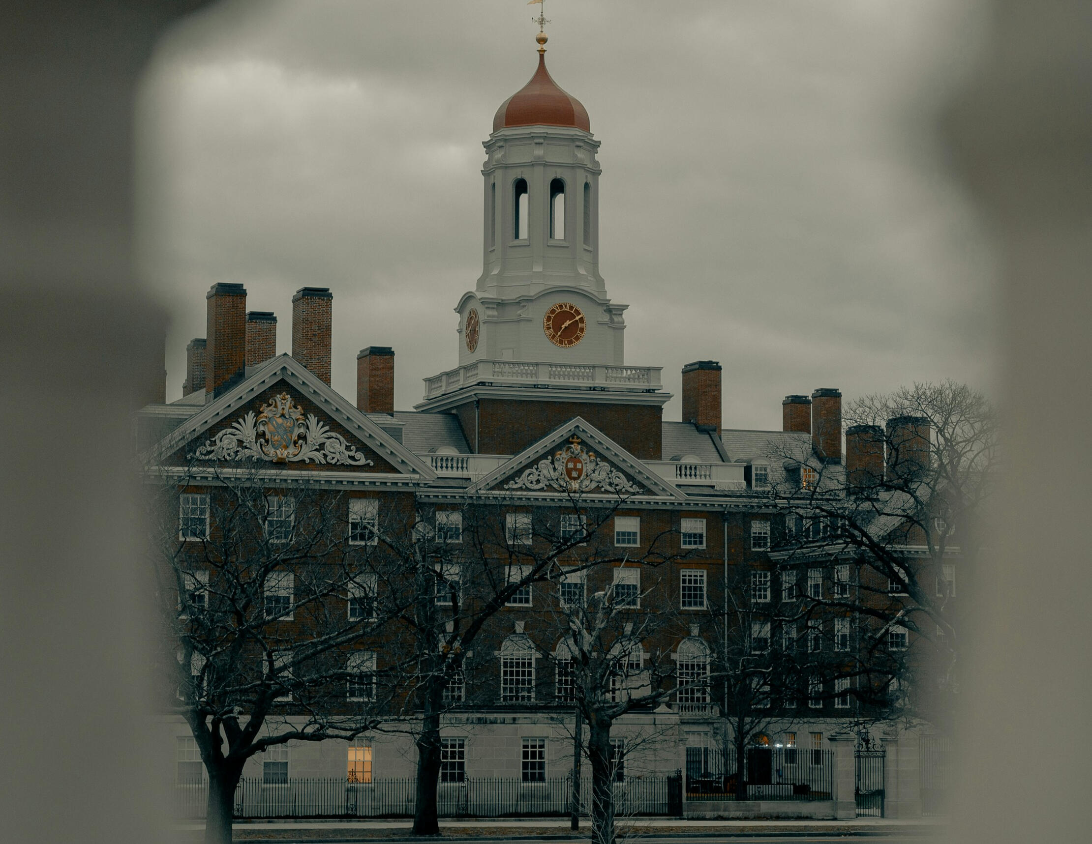 harvard university one of harvard's river houses seen through the rungs of the bridge