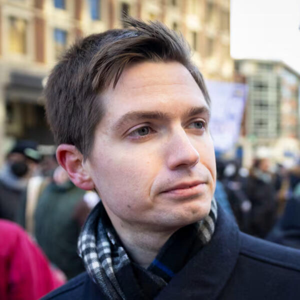 adam sychla adam sychla looking towards the right, wearing a scarf